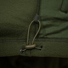 Drawstring Cord Lock on Green Fleece Garment © Алексей Божко