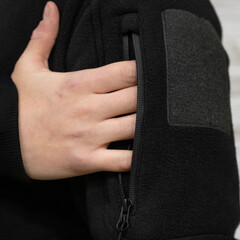 Hand Opening Zippered Pocket on Black Fleece Jacket © Алексей Божко