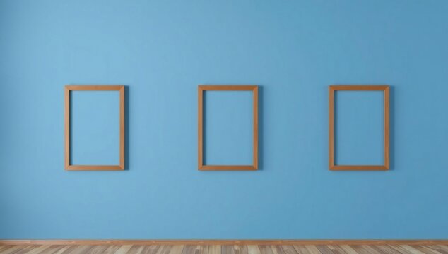 Three empty picture frames on blue wall