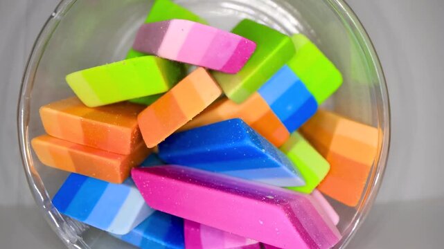 Colorful school erasers close up view in a bowl shot with probe lens.