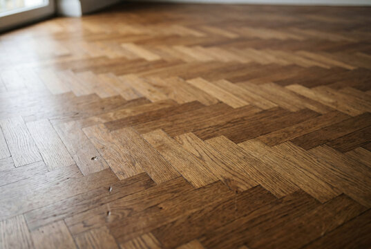 Traditional hardwood parquet flooring with classic herringbone pattern