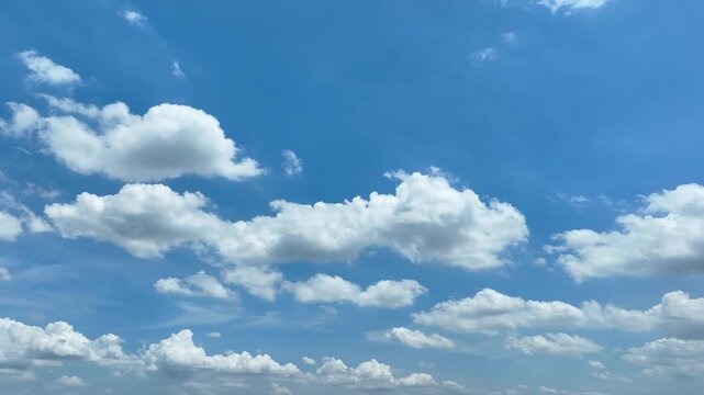 Aerial view from a moving drone capturing bright blue skies and floating cloud formations, symbolizing freedom, optimism, clean air, climate monitoring, and the dynamic movement of the atmosphere. 4k.