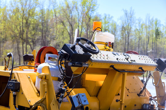 Heavy machinery works in construction area near forest
