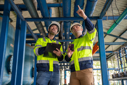 Expert engineers and inspectors are jointly examining the overall operation of the large water treatment plant.