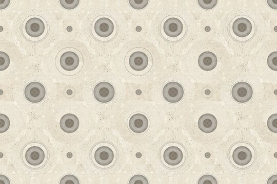 Geometric pattern featuring repeating circular shapes with concentric rings in shades of beige, cream, and soft grey on a textured stone background