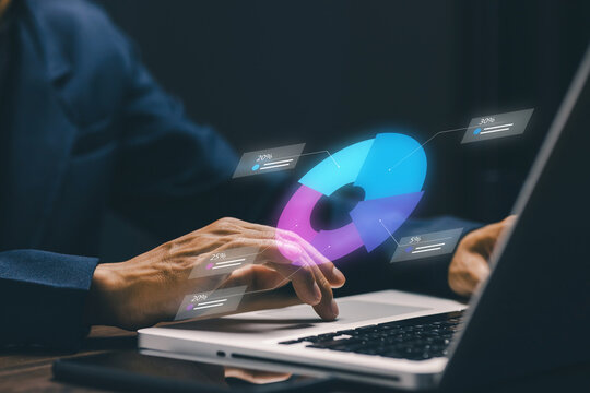 Business professional uses a laptop with a digital donut chart interface, illustrating data analytics, business statistics, financial reporting, performance, and strategic planning.