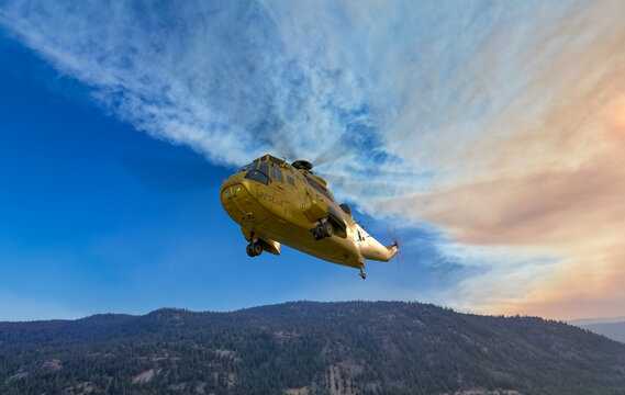 Yellow Rescue Helicopter Flying Over Forested Mountains At Sunrise &mdash; 3D Rendering BC Canada