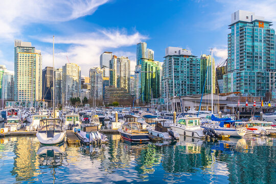 Yachts and downtown skyline reflecting in water at sunset in Vancouver, British Columbia