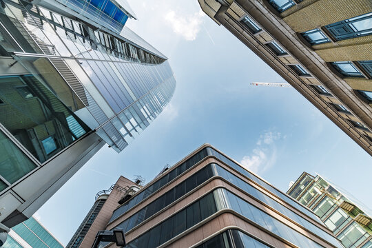 View of modern glass skyscrapers in the City of London under a clear blue sky in London, England, United Kingdom.