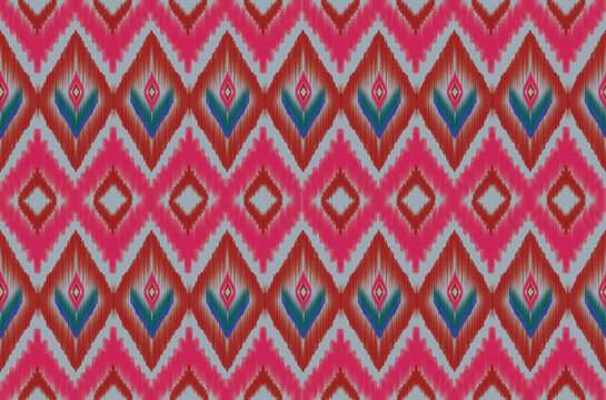 Seamless Ikat Diamond Pattern with Magenta Pink, Red and Green Blue Accents on Powder Blue Background
