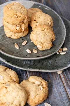 Tasty food. Crunchy biscuits. Baked cookies served stack on wooden table with scattered peanut ingredient. Sweet home meal background.