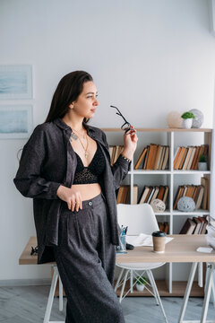 Business lifestyle. Freelance workflow. Inspired relaxed woman specialist at professional office with coffee document at desk.