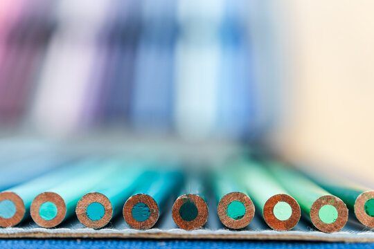 colorful pencils lined up in pencil case with shallow depth of field