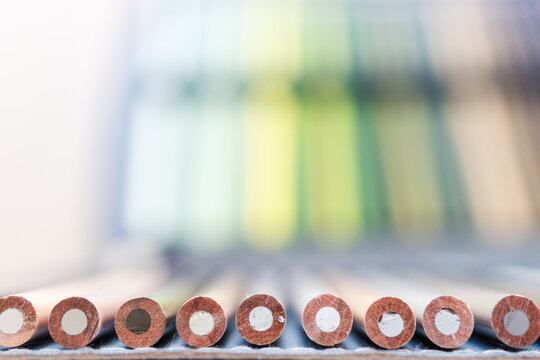 colorful pencils lined up in pencil case with shallow depth of field