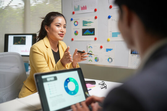 Businesswoman Presenting Analytics in Office Meeting