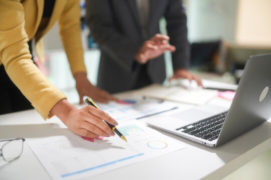 Business Team Analyzing Financial Charts in Office