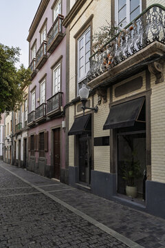 View of historic colonial-style buildings with ornate wrought-iron balconies and cobblestone streets in the Vegueta district of Las Palmas de Gran Canaria, Canary Islands, Spain.