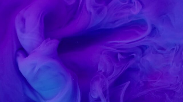 Paint splash. Acrylic pigment. Blur blue purple color glitter fume cloud underwater wet texture spreading on abstract art background.