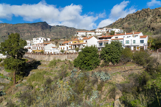 View of the picturesque village of Tejeda with its traditional white houses and terracotta roofs nestled against a rugged mountain landscape in Tejeda, Canary Islands, Spain.