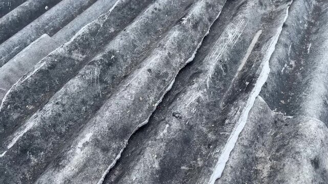 Double cracks on weathered corrugated asbestos roof texture
