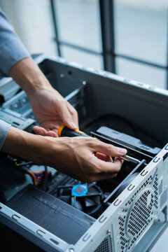 Asian IT engineer using screwdriver fix pc case