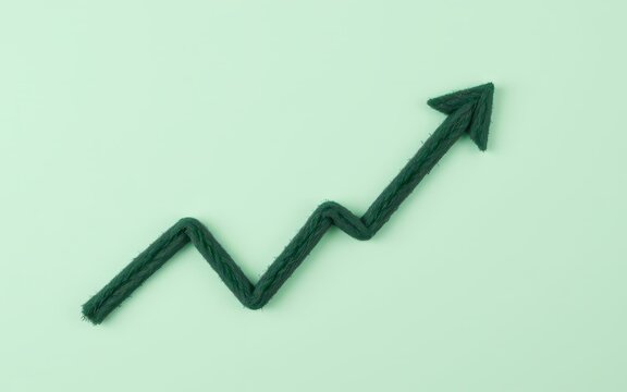 Black upward trending arrow sketch on green background symbolizing growth and success.