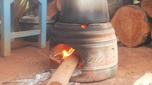 Firewood smolders in a traditional clay oven