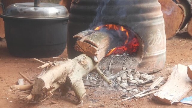 Firewood smolders in a traditional clay oven