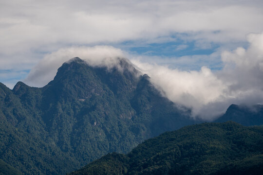 Majestic green mountains covered by flowing white clouds in Y Ty, Lao Cai province, Vietnam