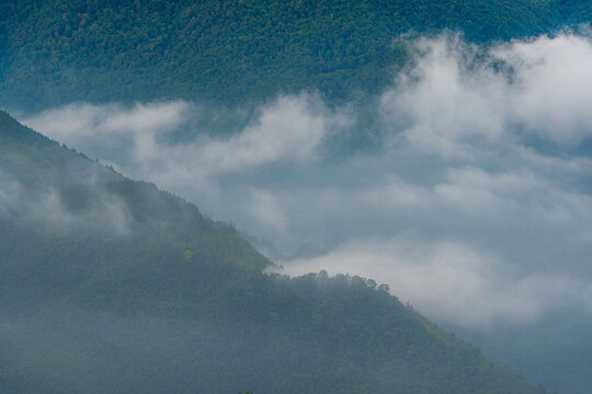 Majestic green mountains covered by flowing white clouds in Y Ty, Lao Cai province, Vietnam