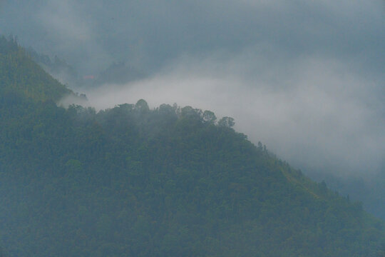 Majestic green mountains covered by flowing white clouds in Y Ty, Lao Cai province, Vietnam