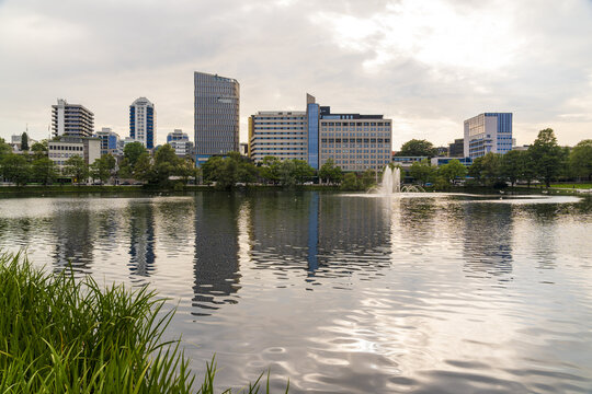 View of the Breiavatnet lake with a fountain and modern city skyline in the background in Stavanger, Rogaland, Norway.
