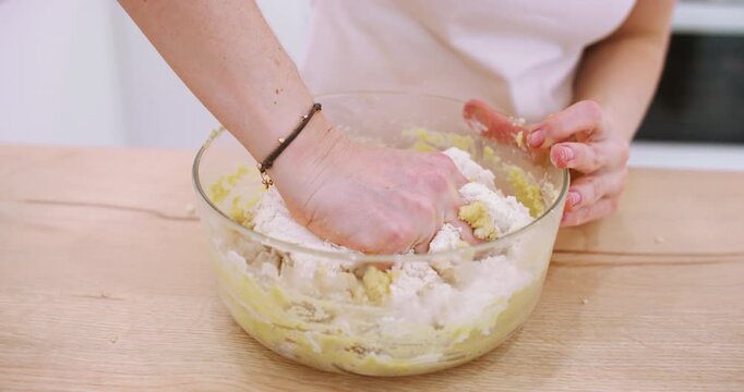 Cooking dough. Pouring flour. Female confectioner hand adding baking ingredient to bowl preparing tasty food recipe at home kitchen.