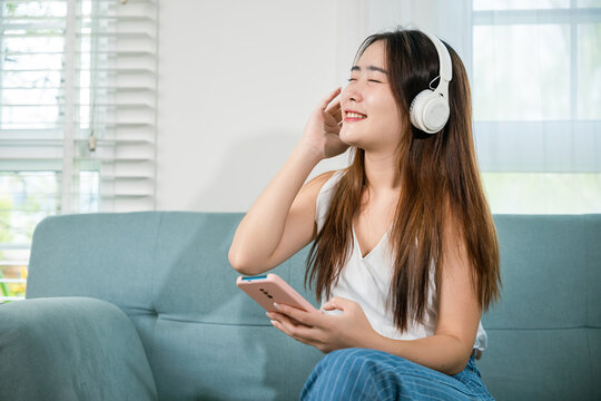 Woman wear earphone listen music application on smartphone