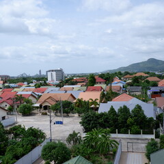 Fototapeta premium Panoramic Aerial View of Suburban Village Homes with Mountain Backdrop