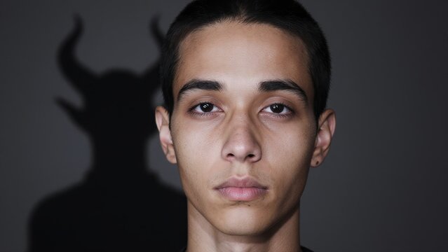Portrait of Young Man with Mysterious Shadow and Intense Expression