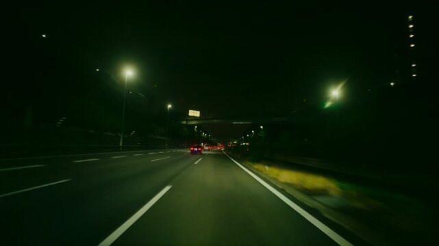 Urban expressway in Tokyo with high rise buildings and night lights