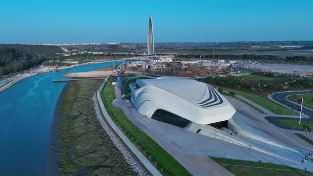 Blue hour drone view of the Bouregreg Valley featuring the Grand Theatre of Rabat, VI Tower and riverfront redevelopment linking Rabat and Sal&eacute;, Morocco.