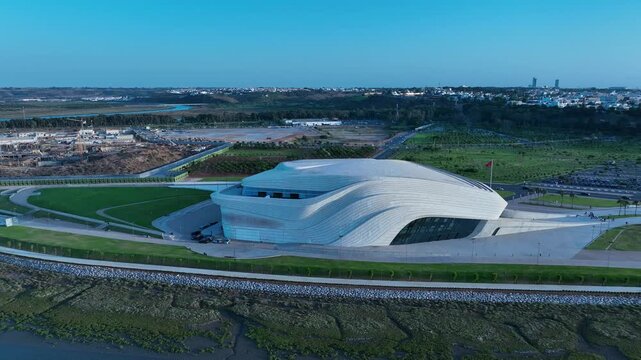 Blue hour drone view of the Grand Theatre of Rabat within the Bouregreg Valley redevelopment area, showcasing contemporary architecture and Morocco's expanding urban waterfront.