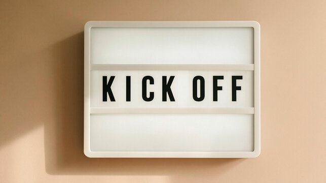 Kick Off Announcement: A modern light-up sign displays the prominent words KICK OFF, signaling the start of a new project, event, or campaign, set against a soft, neutral background.