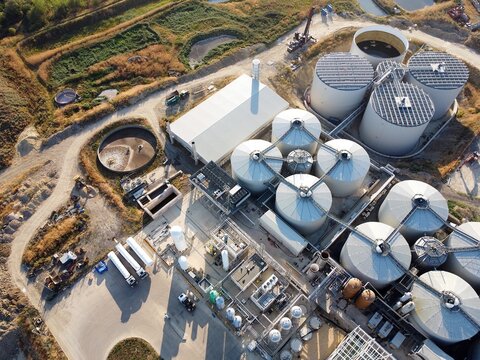 Aerial view of the RenEco industrial facility featuring large storage tanks, processing buildings, and surrounding infrastructure in Wymington, England, United Kingdom.