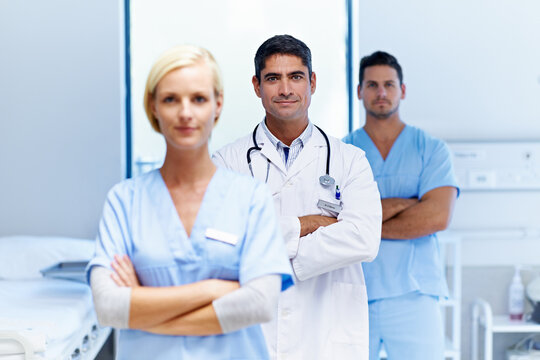 Doctor, team and arms crossed in clinic for medical support, primary healthcare and about us pride. Staff portrait, people and nurses with confidence in ward for patient care, health service or trust