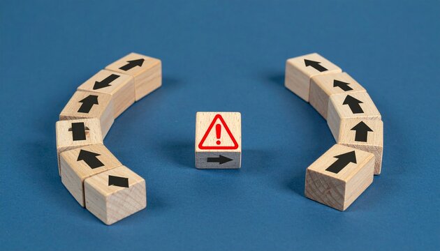 Wooden blocks with arrows converging toward central warning sign