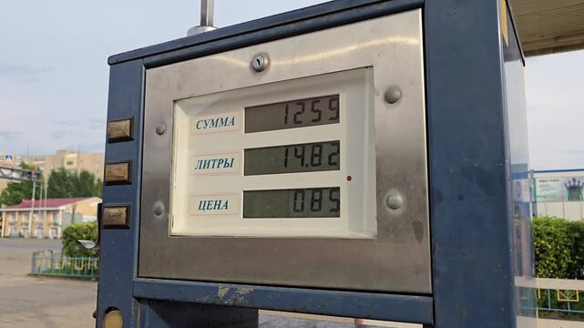 A close-up of the digital display on an old gas pump at a gas station. LPG shortage in Kazakhstan. The total and liter counts increase during refueling.