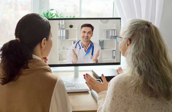 Doctor patient senior caregiver video chat call. Two women consult a doctor by computer, discuss symptoms and care via telemedicine. Telemedicine consultation defines remote healthcare concept.