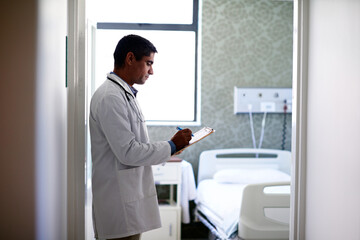 Fototapeta premium Clinic, doctor or writing on medical checklist for discharge records, care coordination or notes. Health worker, serious man and clipboard for ward round, admission information and hospital workflow
