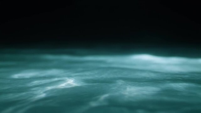 Aqua-toned water weaves through continuous gentle currents, light revealing moving surface texture and subtle depth against near-black with calming natural atmosphere and smooth motion.