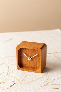 A small wooden desk clock on washi paper