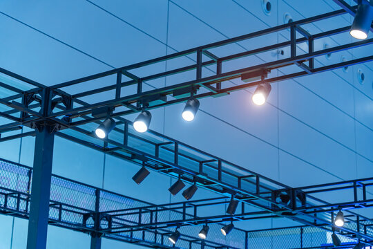 Directional LED lights on rails under the ceiling in a modern warehouse, shopping center building, office or other commercial real estate object.