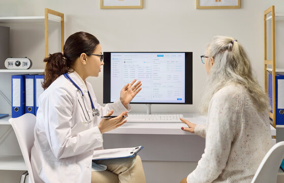 Doctor and senior patient consultation about results. In a clinic, physician explains computer data, reviews diagnosis and offers advice for ongoing healthcare. Clear concept of trust in care.